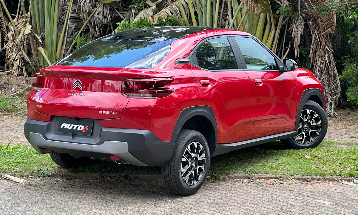 Citroën Basalt Shine vermelho com teto preto parado em frente a uma floresta