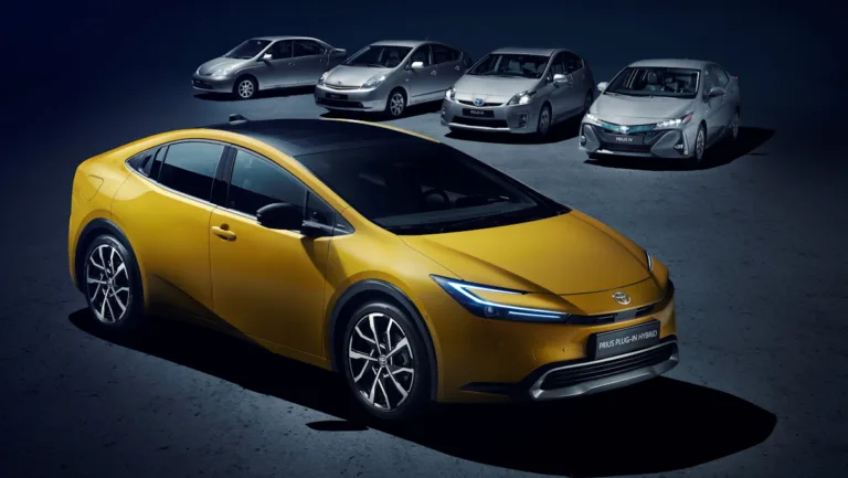 Toyota Prius de quarta geração amarelo com as outras três gerações brancas ao fundo