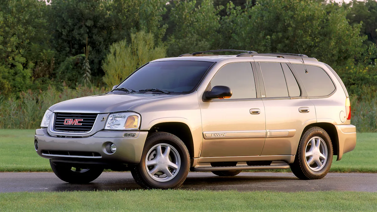 GMC Envoy prata de frente em uma floresta