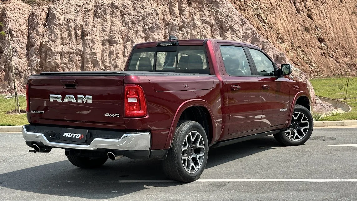 Nova Ram 1500 Laramie parada de traseira com morro ao fundo