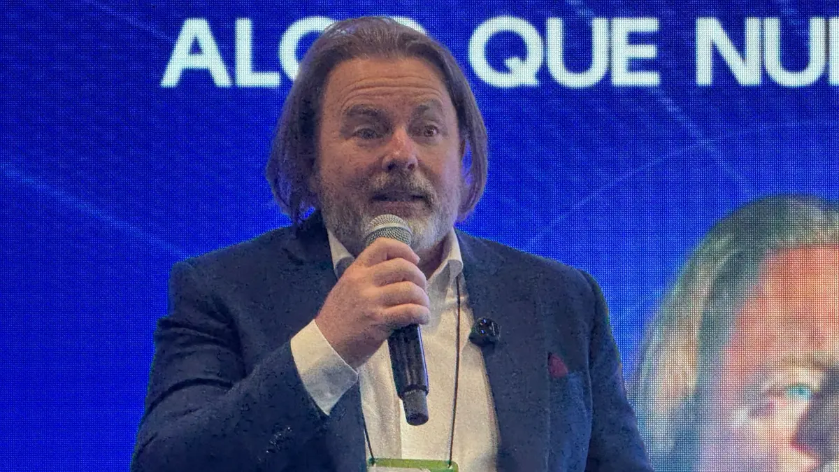 Fundador da Lecar, Flávio Figueiredo de Assis, segurando microfone enquanto dialoga com a imprensa