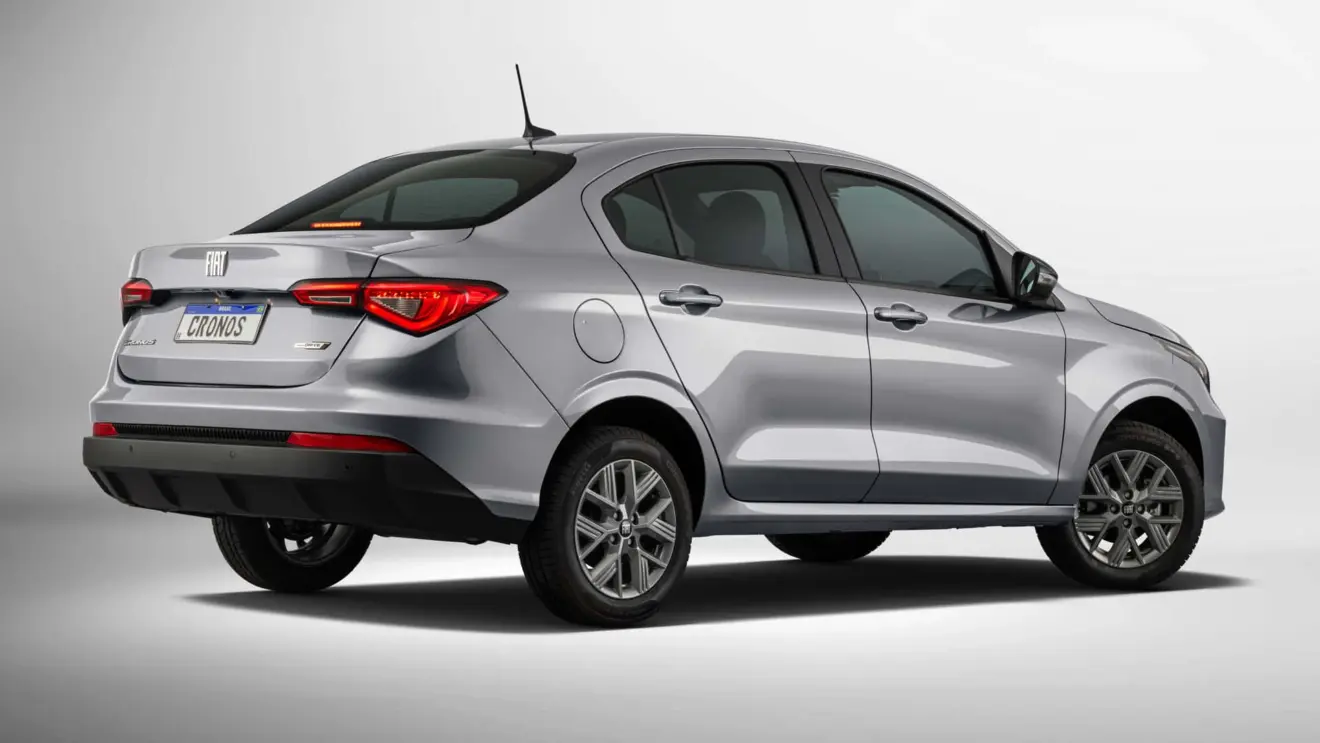 Fiat Cronos Drive 1.0 prata, visto de trás e com lanternas acesas