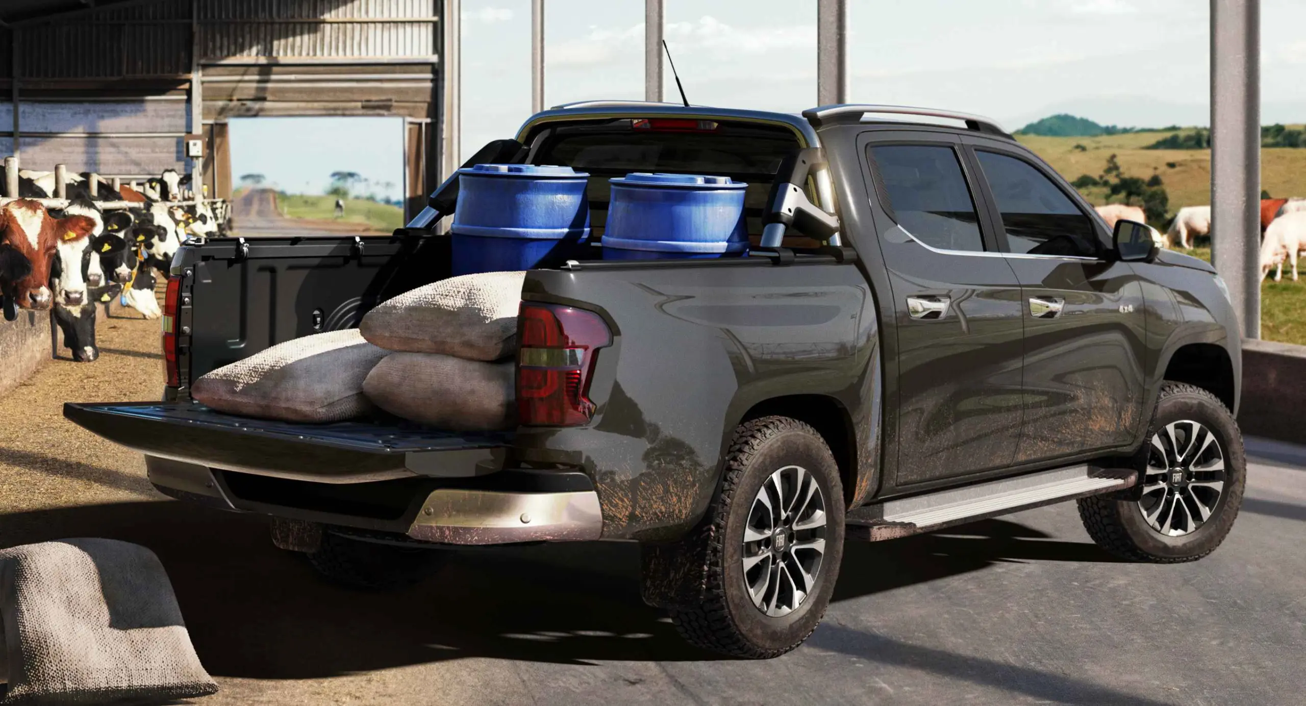 Fiat Titano Ranch 2026 cinza parada de traseira com a tampa da caçamba aberta