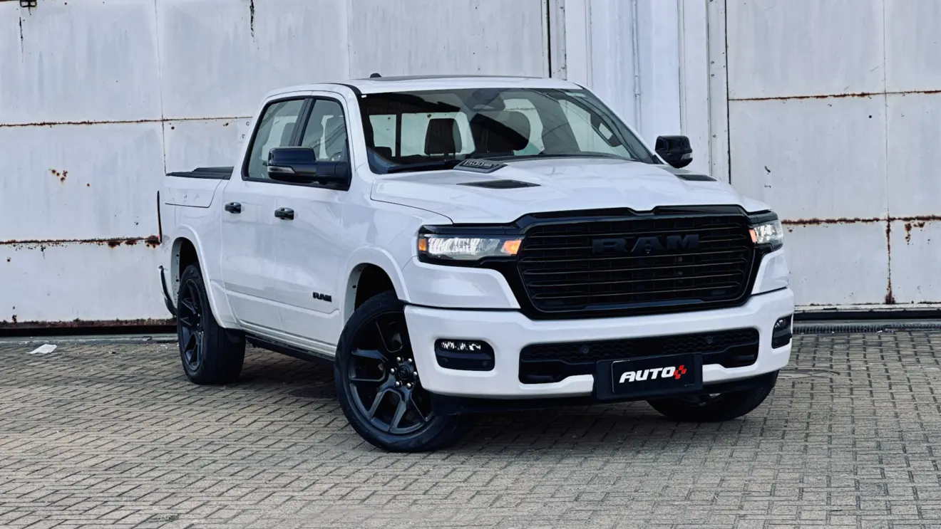 Ram 1500 Laramie Night Edition branca com detalhes pretos de frente com uma parede branca ao fundo